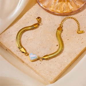 Detailed view of a gold stainless steel snake chain bracelet with a heart-shaped iridescent charm