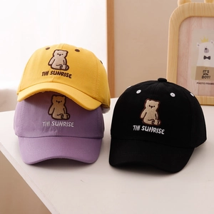 Detailed embroidery of cartoon bear and THI SUNRISE text on colorful kids baseball caps