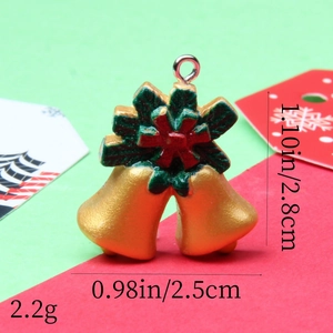 Close-up of resin Christmas bell pendants with holly berries and size specifications