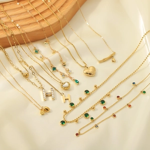 Golden stainless steel necklace collection with heart, letter H and emerald pendants
