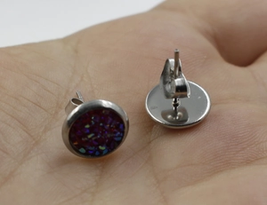 Detailed view of 8mm silver stainless steel stud earrings with deep purple druzy crystals