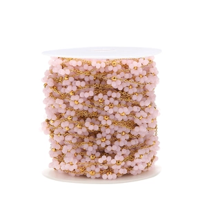 Detailed macro view of 1.5mm pink beaded flower chain with gold stainless steel finish