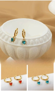 Detail of heart-shaped blue and red zircon pendant earrings in titanium steel with gold plating