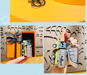 Cartoon dinosaur tank car keychain with metal ring and bell in a premium orange gift box