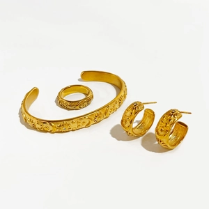 Golden stainless steel jewelry set featuring celestial sun and moon relief carvings
