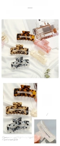 Detail of tortoise shell and marble hair claw clips with 210-degree opening mechanism