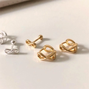 Detailed close-up of gold and silver 925 sterling silver twist cross earrings set