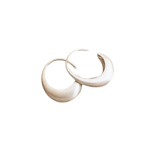 Minimalist silver geometric crescent hoop earrings with brushed metallic texture and C-shape