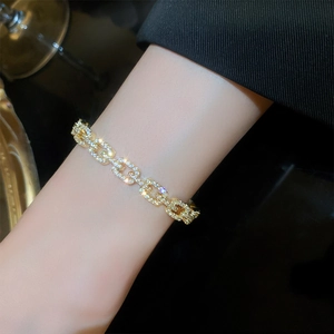 Macro shot of gold plated chain bracelet with micro-paved cubic zirconia crystals