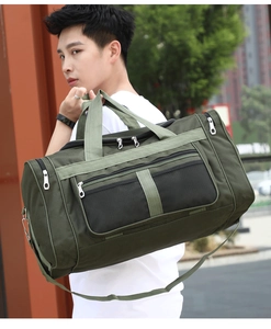 Outdoor lifestyle shot of a large green travel bag with mesh pocket and shoulder strap