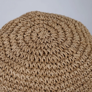 Overhead view of a Japanese-style straw bucket hat showing intricate spiral weave detail