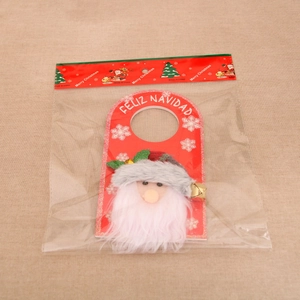 Close-up of Santa Claus door hanger in packaging with Feliz Navidad greeting and bells