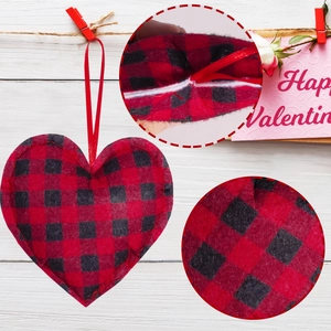 Detail of buffalo plaid heart ornaments with silk hanging ribbons for festive decor