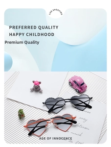 Detail of heart-shaped kids polarized sunglasses in orange and black with metal hinges