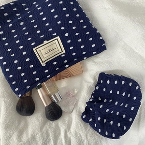 Navy blue polka dot chiffon pouch set with unique pleated texture and fabric label