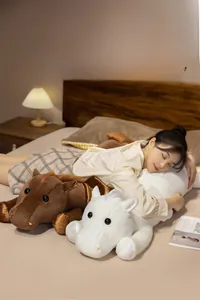 Soft plush horse pillow for sleeping shown in a cozy bedroom scene with models