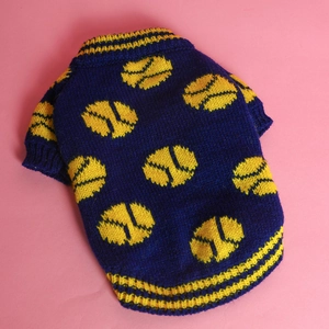 Detailed close-up of dark blue knitted pet sweater with yellow tennis ball patterns