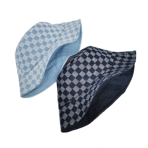 Close-up of checkerboard pattern denim bucket hats in light and dark blue styles