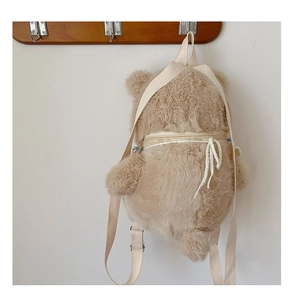Detail of cute khaki teddy bear plush backpack with adjustable straps and back zipper