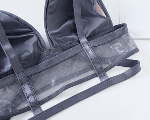 Close-up of breathable mesh back band and smooth fabric on a dark gray camisole bra