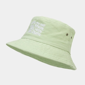 Detail of light green bucket hat with white 'LOVE MY BODY' embroidery and metal eyelets