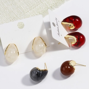 Detail of retro geometric resin U-shape earrings with gold trim in various colors