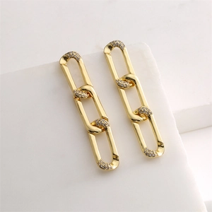 Detailed view of gold chain drop earrings with sparkling pavé-set zircon accents