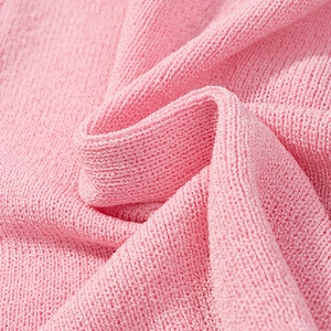Close-up macro of pink knitted sweater fabric showing soft breathable texture and weave