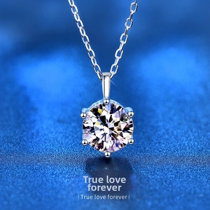 Detail of a 2-carat six-prong round moissanite pendant with a silver necklace chain
