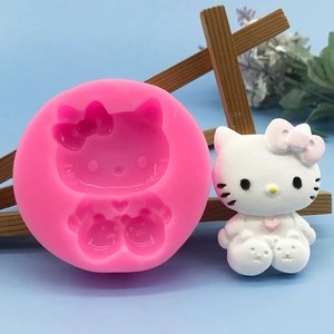 Pink silicone mold for cartoon cat cakes and candles with a 3D finished white kitty model