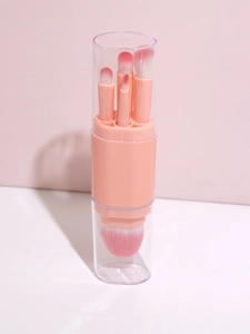 Detailed view of pink 5-in-1 retractable makeup brush set in a transparent cylinder case