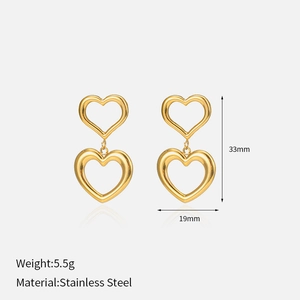 Detail view of gold double heart earrings showing size dimensions 33mm by 19mm in 18K finish