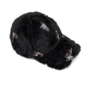 Top view of thick black faux fur baseball cap with floral embroidery for winter warmth