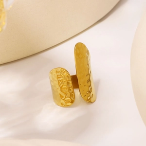 Minimalist oval hammered 18K gold-plated stainless steel ring on beige background