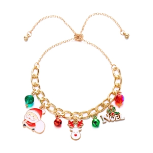 Detailed shot of Christmas charm bracelet with Santa, reindeer, and NOEL charms