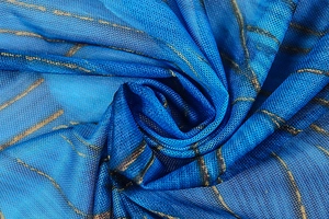 Detail of blue mesh fabric featuring gold marble print and lightweight texture