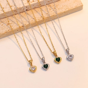 Elegant heart-shaped emerald jewelry set including gold and silver necklaces and earrings