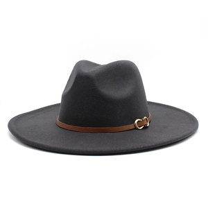 Macro detail of dark grey wide brim fedora hat with brown leather band and metal buckle