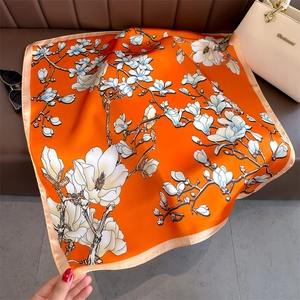 Elegant 70cm square silk scarf with white magnolia print on bright orange fabric