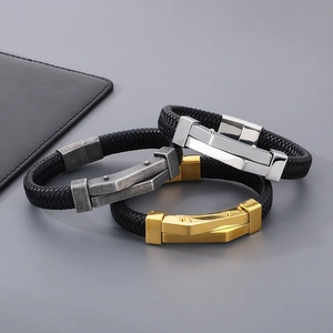 Detail of woven black leather bracelets with magnetic steel clasps in gold, silver, and grey