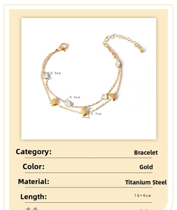 Macro view of double-layer gold titanium steel bracelet with heart charms and marquise zircon