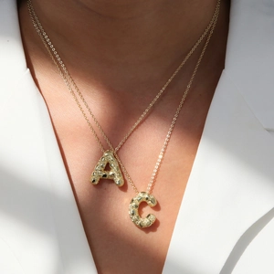 Golden balloon bubble initial necklace featuring letter A and C pendants for women