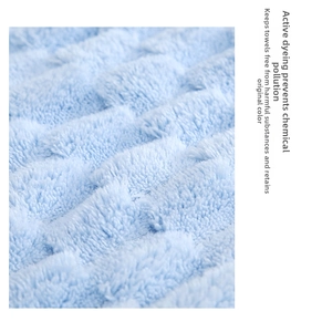 Macro shot of light blue towel with thick 3D wave texture and soft fluffy fabric details