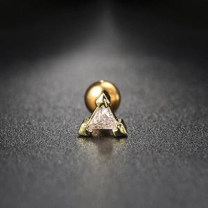 Macro shot of gold triangular stud earring with clear zircon and screw back closure