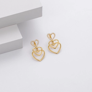 Detail of gold heart earrings with triple-layered design and sparkling micro-inlaid zircons