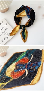 Macro view of artistic elephant print on pleated silk scarf with colorful textures