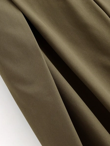 Detailed close-up of dark olive green twill fabric with a smooth draped texture
