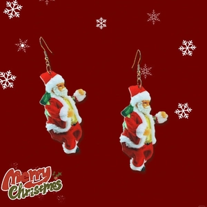 Detailed view of Santa Claus acrylic drop earrings with festive snowflake background