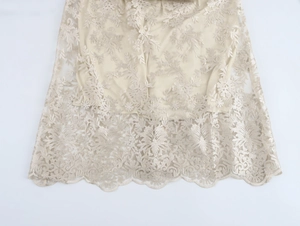 Dettaglio dell'orlo in pizzo ricamato francese beige con bordo a smerlo