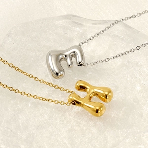 Polished 18K gold bubble letter E and H pendants on elegant steel chains